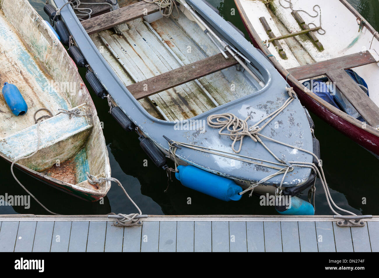 A line of old boats tied to a pontoon, viewed from above. Stock Photo