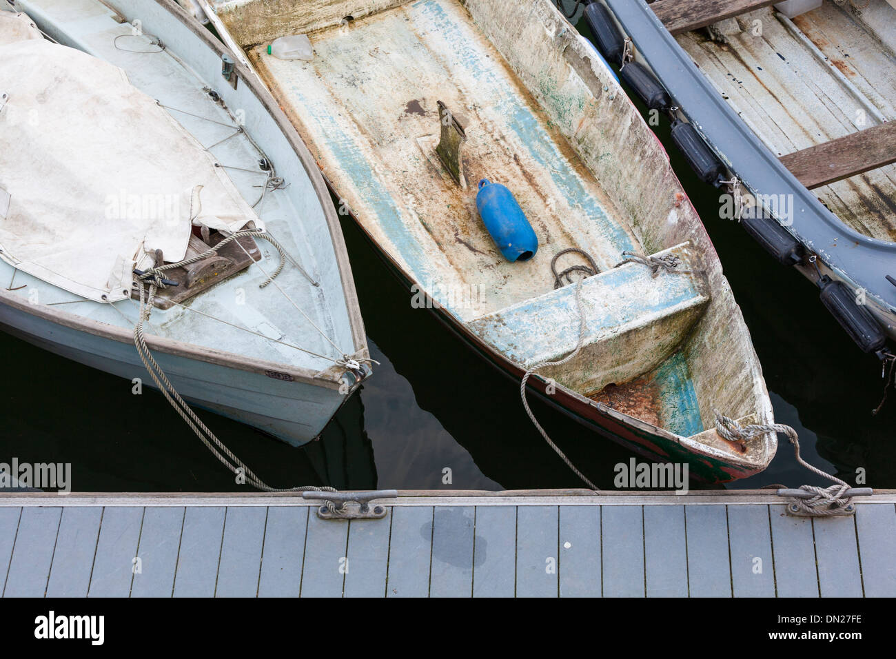 A line of old boats tied to a pontoon, viewed from above. Stock Photo