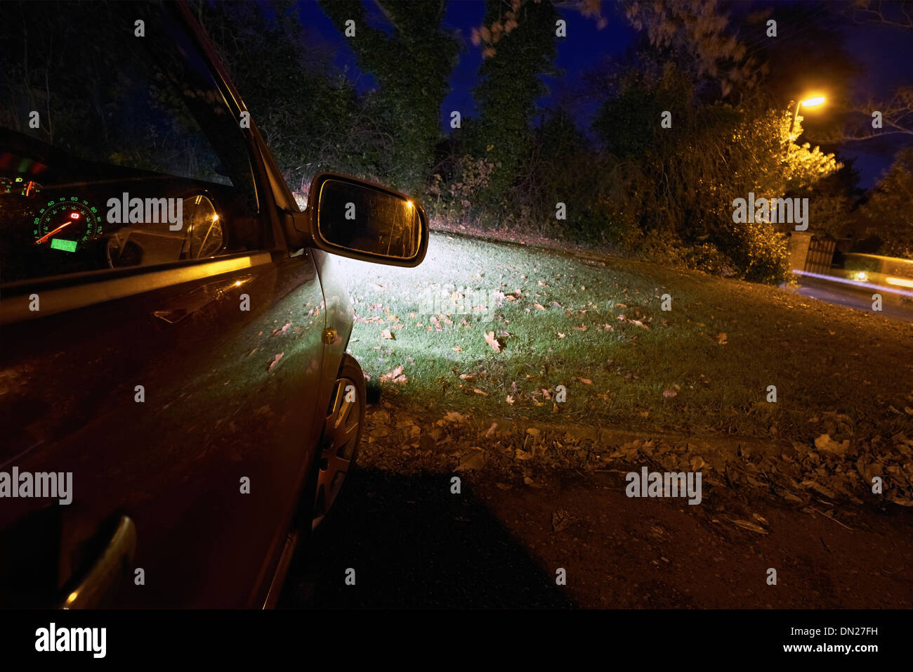 Parked car on a dark street at night. Stock Photo