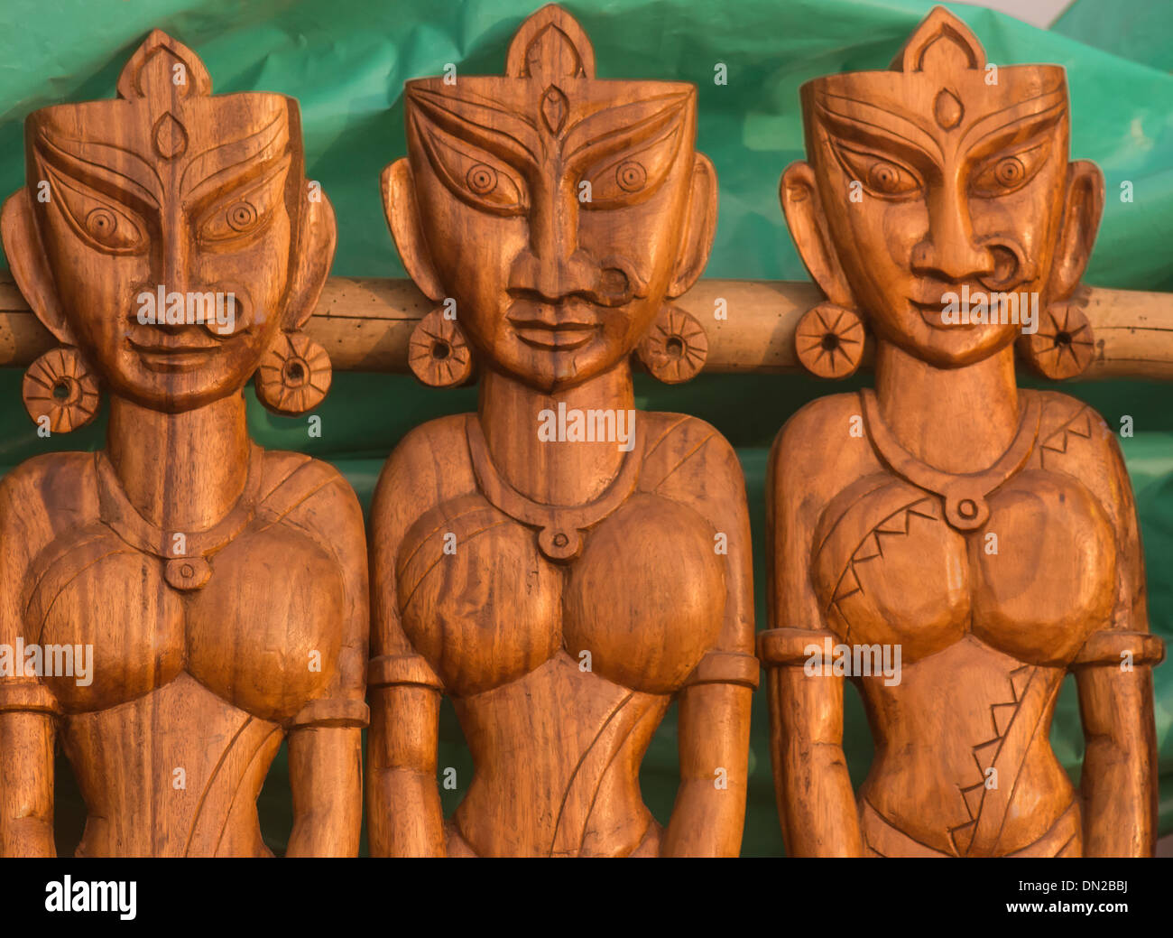 Handicraft in wooden sculpture three ornamented Indian Women. Stock Photo