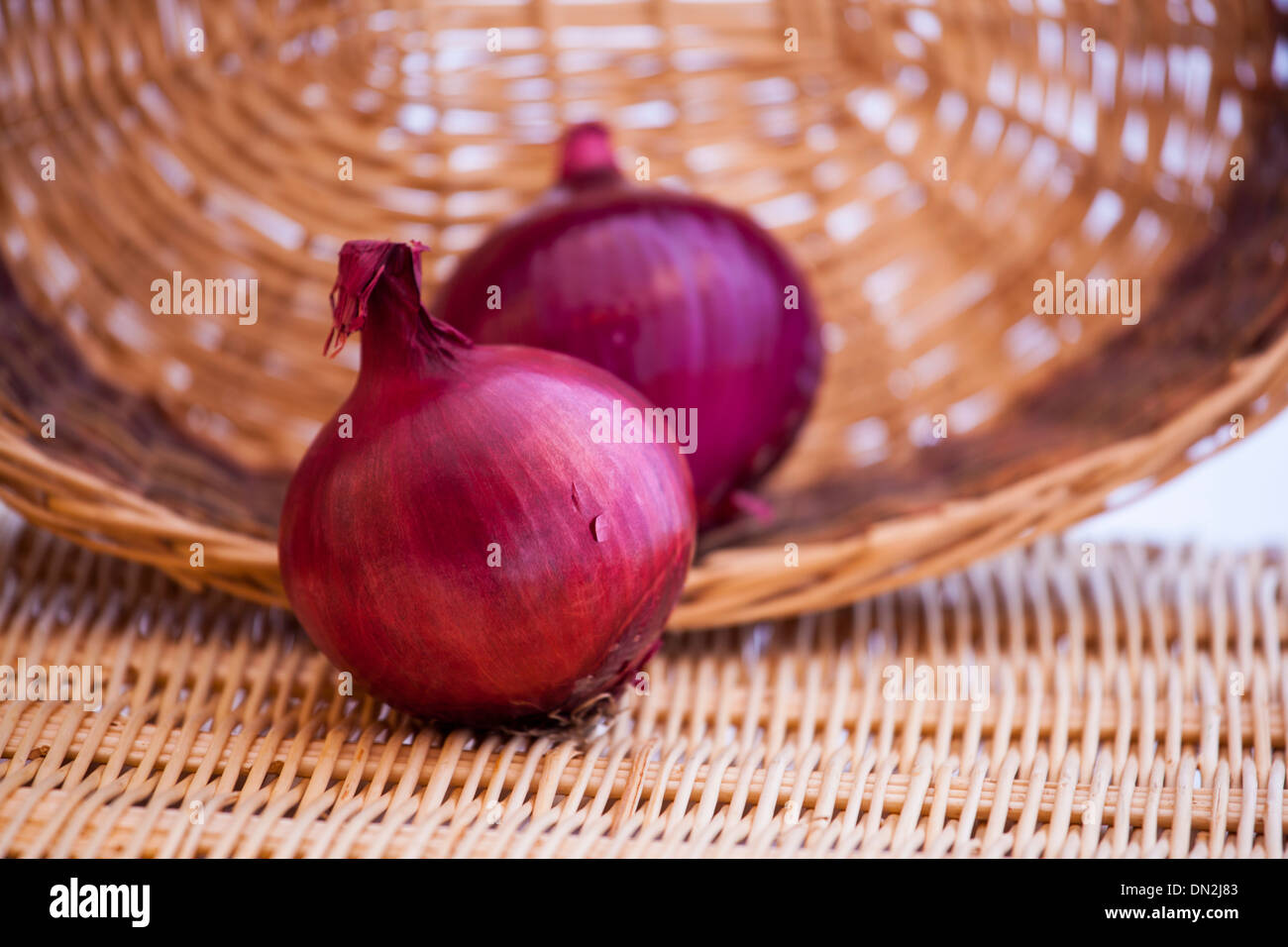 Onions in a wicker basket Stock Photo Alamy