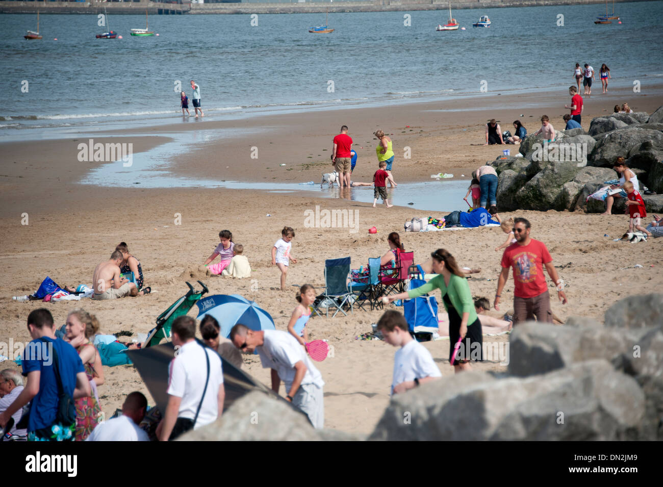 People on New Brighton Beach Merseyside busy fun Stock Photo