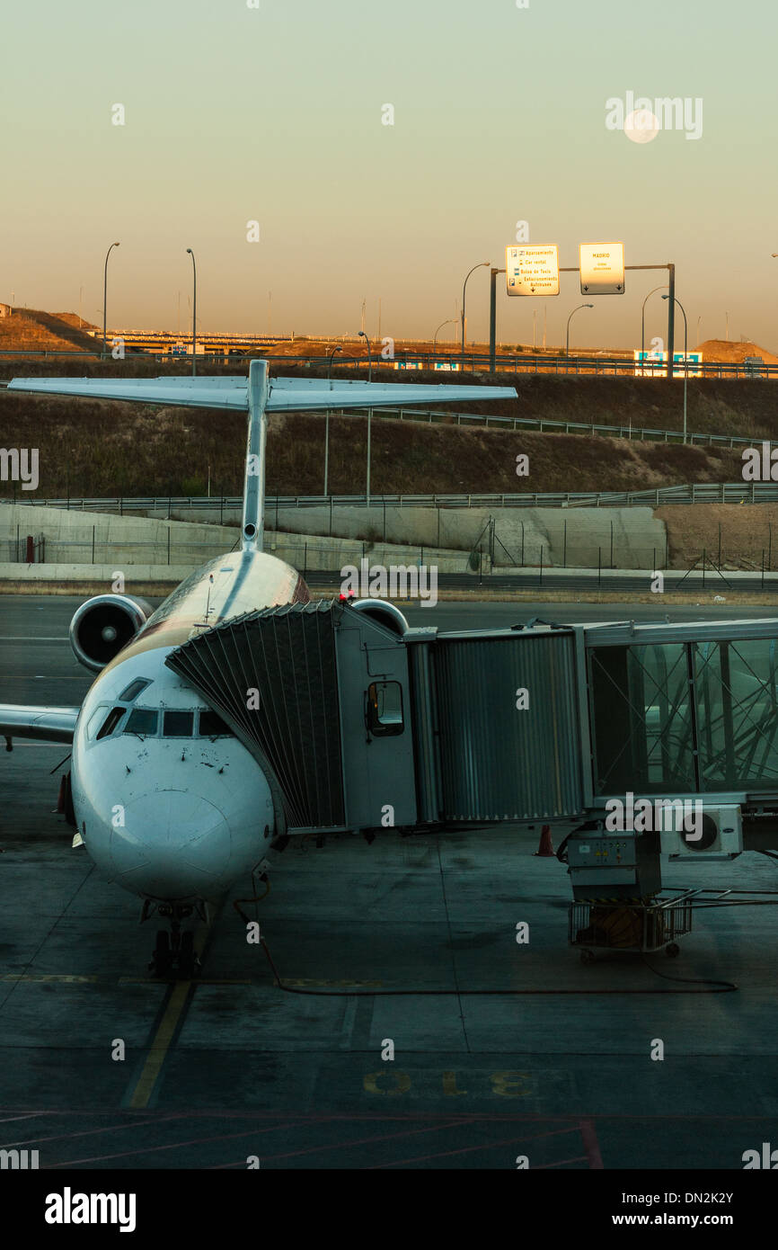 Iberia plane linked to the jetway at the terminal, waiting for the