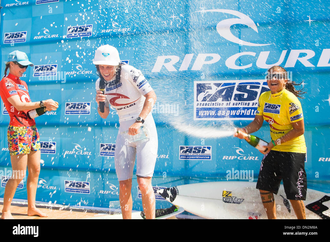 Sep 03, 2006; Hossegor, South West Coast, FRANCE; Reigning ASP world champion CHELSEA GEORGESON (Gold Coast, Aus) (pictured center) celebrates her victory in a shower of champagne at the prize giving of the Rip Curl Pro Mademoiselle in Seignosse, France today. Melanie Redman-Carr (WA, Aus) (pictured left) finished runner up and Silvana Lima (Bra) (pictured right) placed equal third Stock Photo