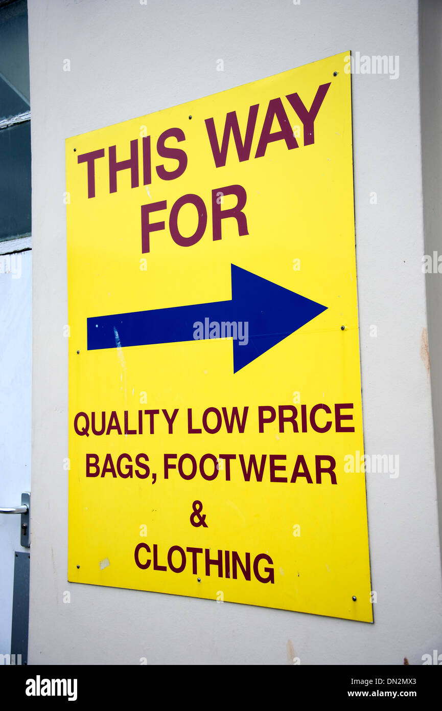 This Way for Quality Low Price Bags Footwear & Clothing Sign Stock Photo