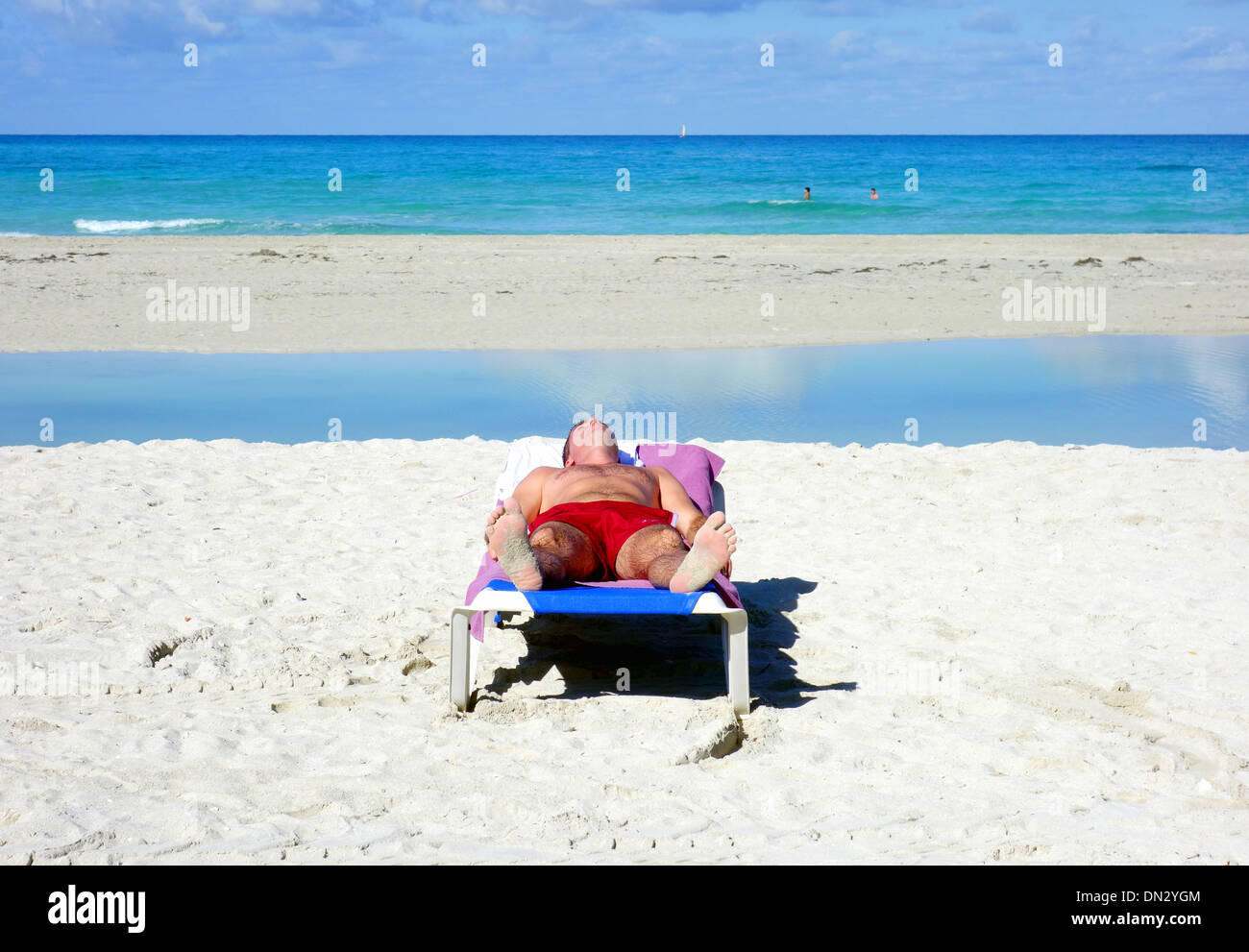 Man sunbathing on a beach in Varadero, Cuba Stock Photo