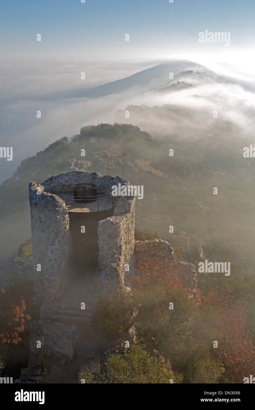 Sunrise over the Castillo de Monfrague with fog rolling over the hills Stock Photo