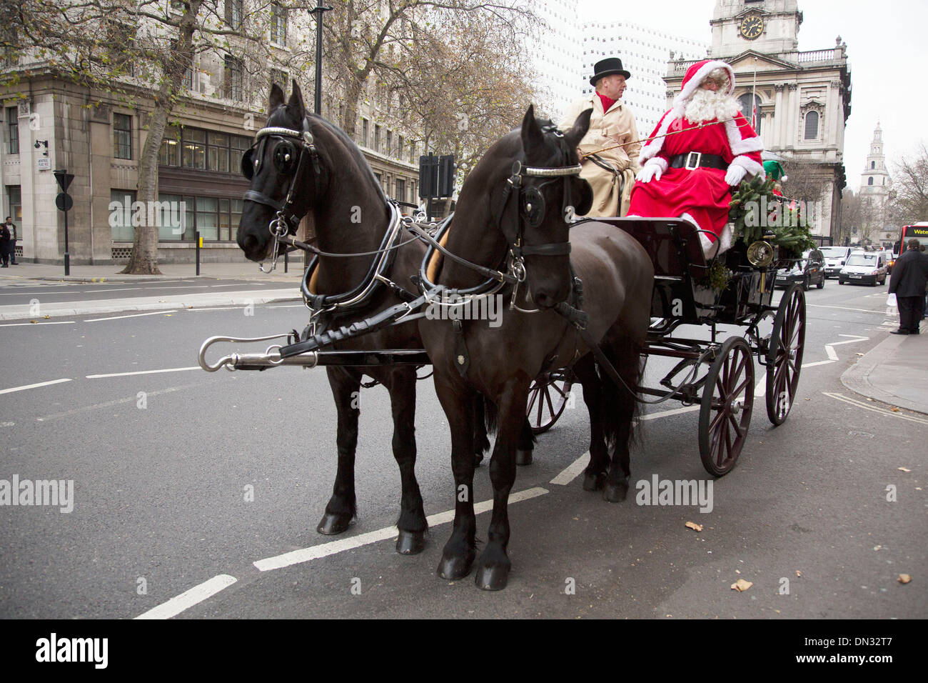Santa Clause in a horse drawn carriage driving through central London ...