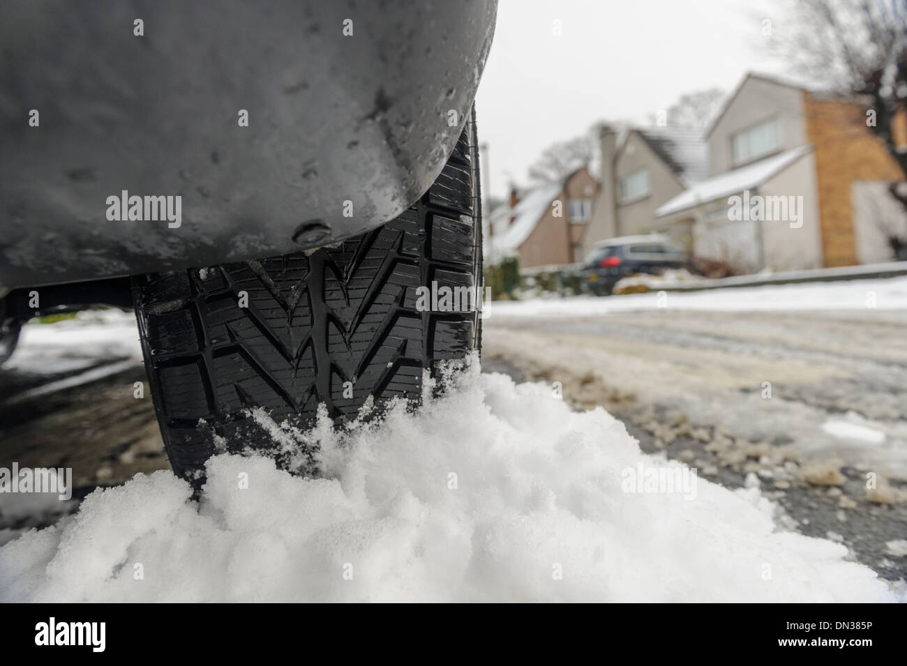United Kingdom, winter tyre tread on car with snow in background Stock Photo