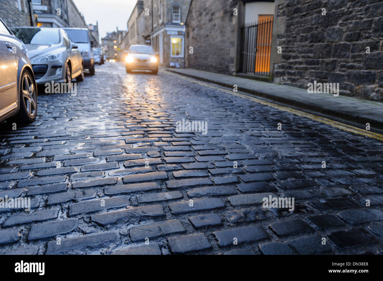 United Kingdom, cars on coblbled street in wet winter conditions Stock Photo