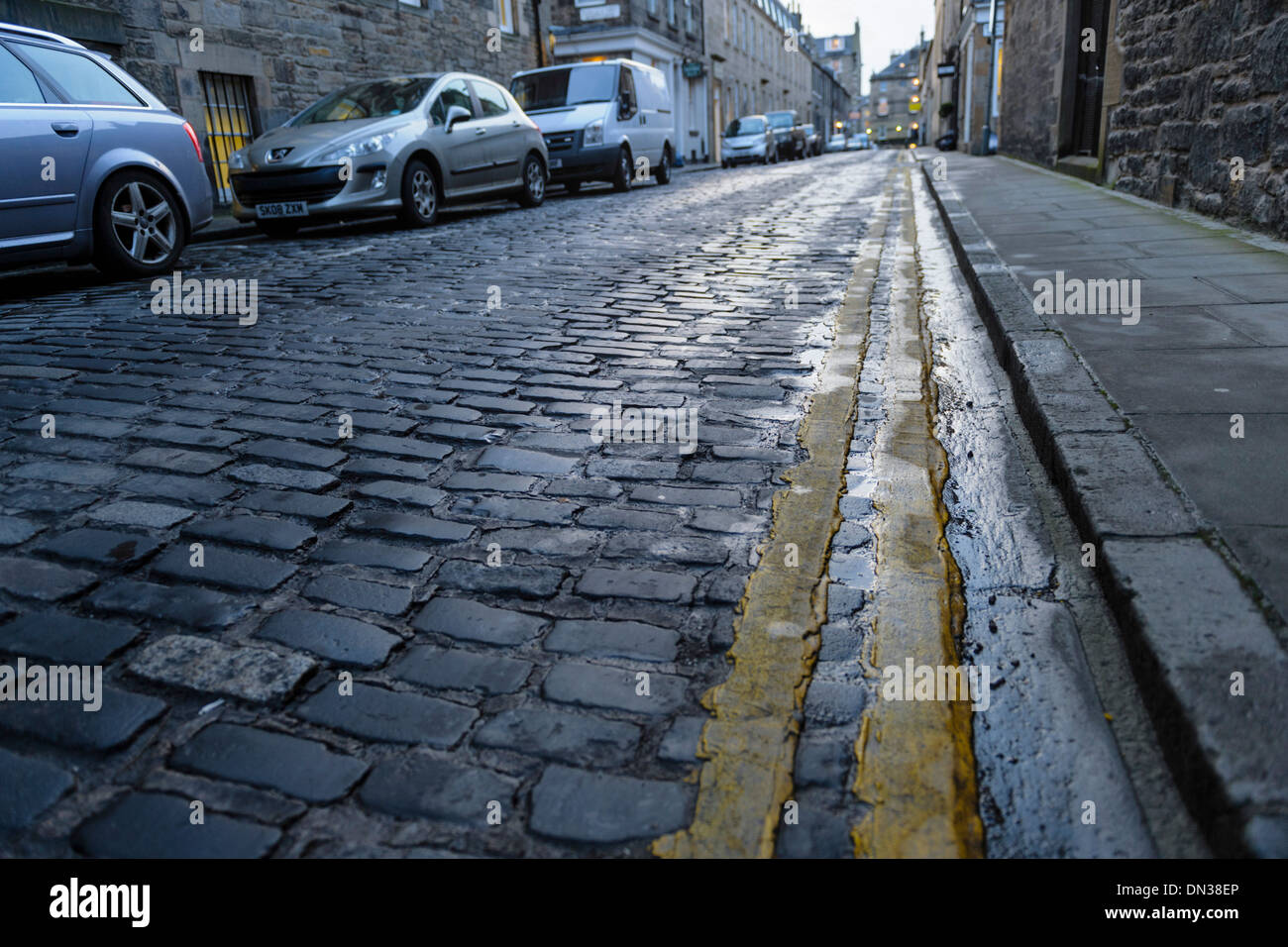United Kingdom, cars on coblbled street in wet winter conditions Stock Photo
