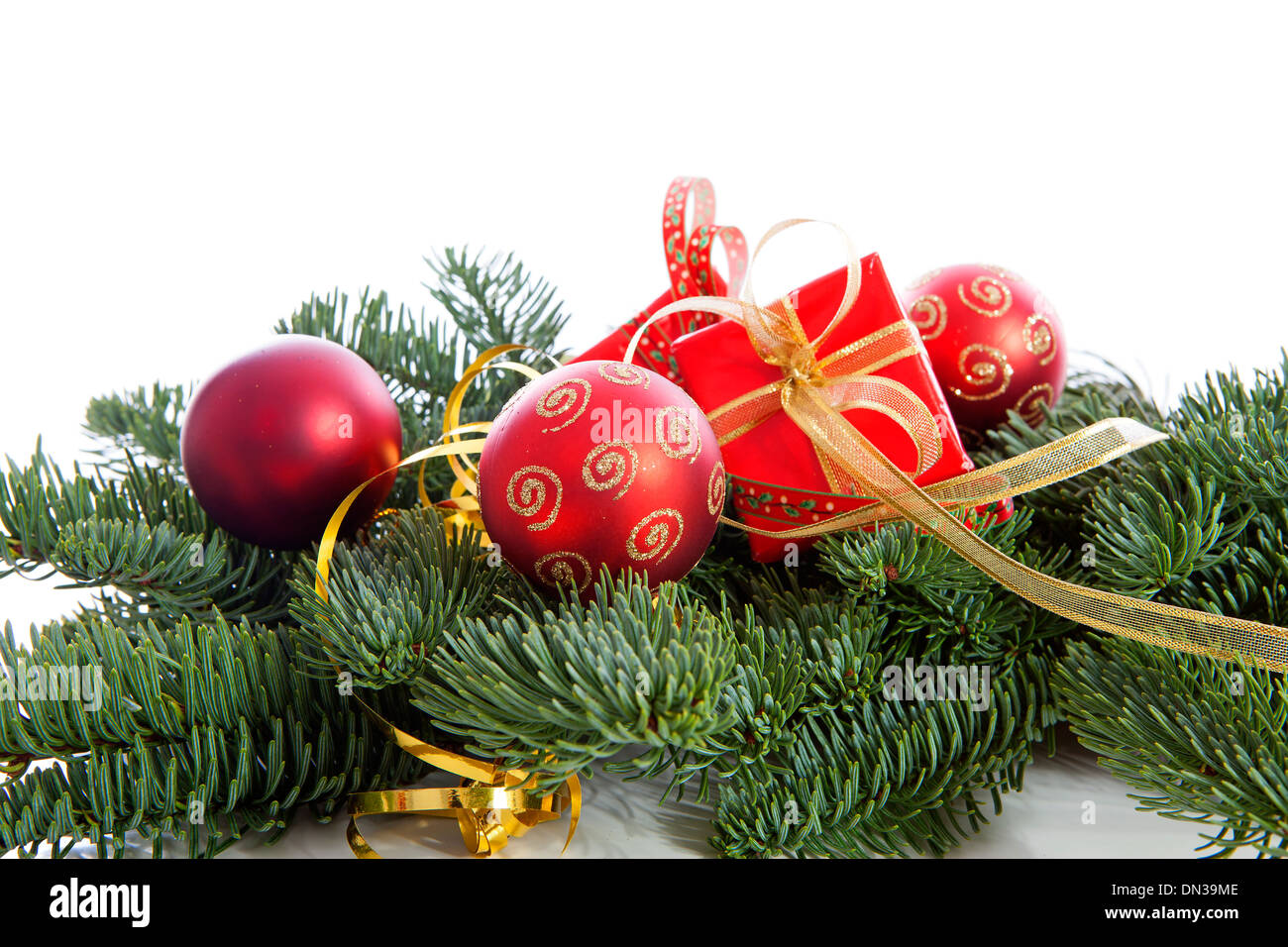 Red Christmas decoration on pine tree over white background Stock Photo