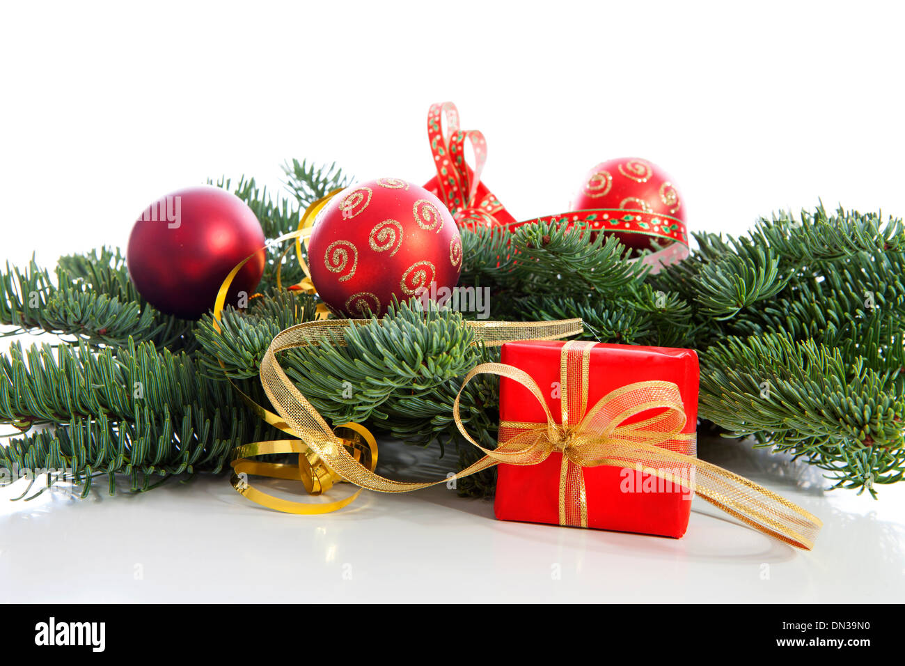 Red Christmas decoration on pine tree over white background Stock Photo