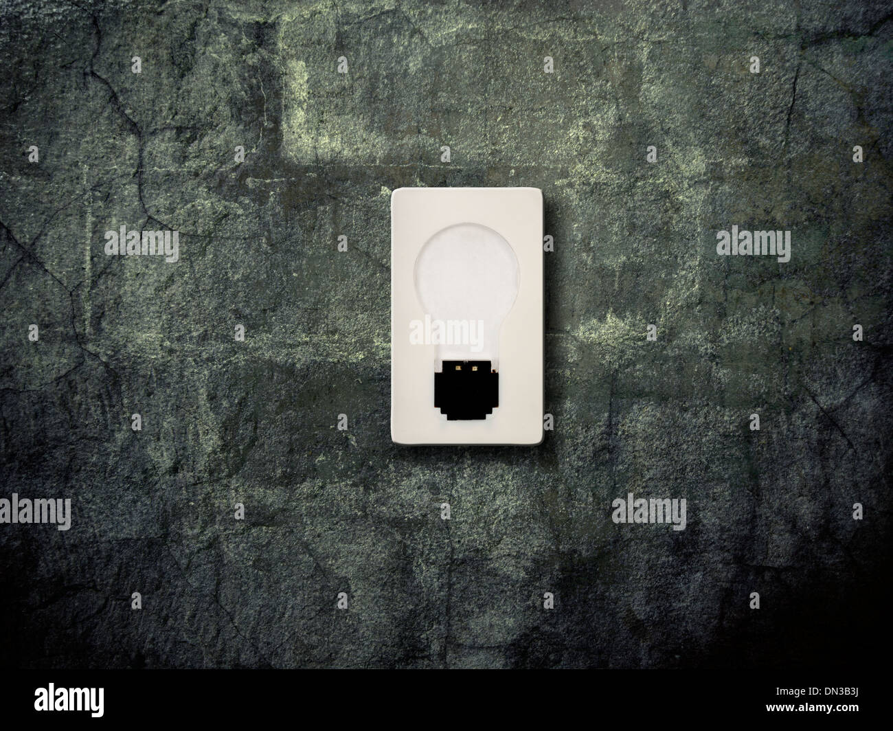 old light switch on a grunge wall Stock Photo