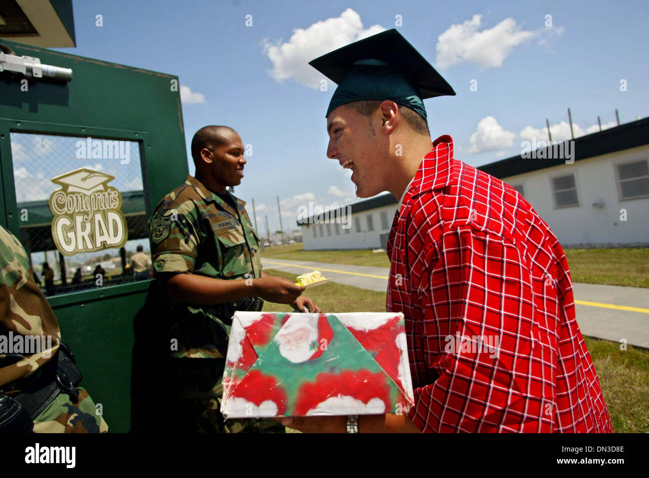 Jun 09, 2006; Stuart, FL, USA; Matthew Gonzalez, 17, passes DI C. Young as he enters the reception on Friday  following graduation ceremonies for the Martin County Sheriff's Office Juvenile Offender Training Center. Mandatory Credit: Photo by Amanda Voisard/Palm Beach Post/ZUMA Press. (©) Copyright 2006 by Palm Beach Post Stock Photo