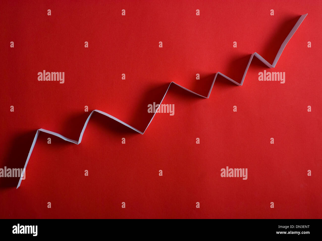 white arrow graph on red background Stock Photo