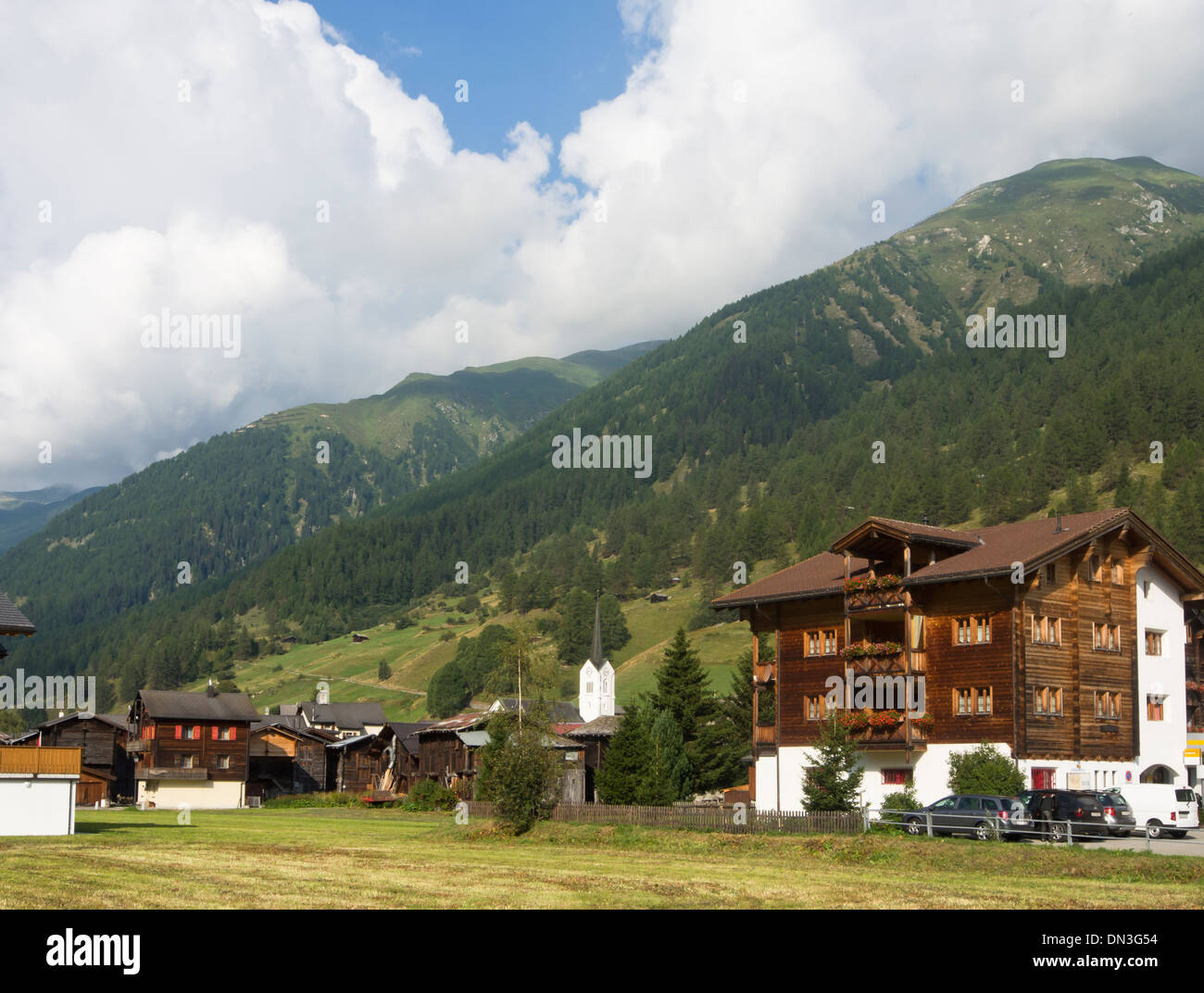 Old and new typical traditional wooden timber houses in the village Ulrichen in the district of Goms in the Swiss alps Stock Photo