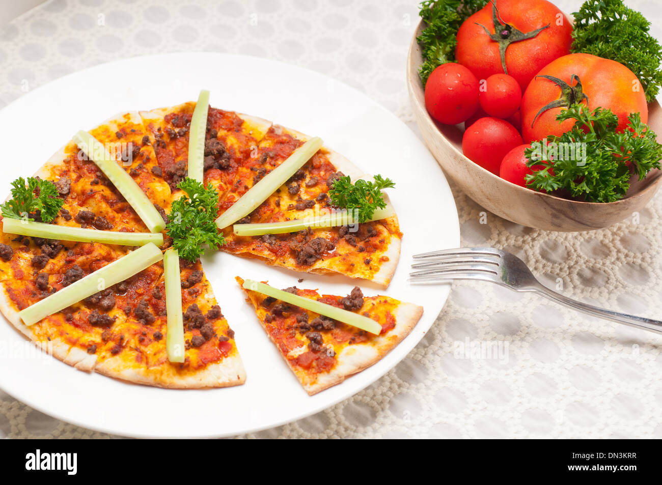 fresh baked Turkish beef pizza with cucumber on top Stock Photo