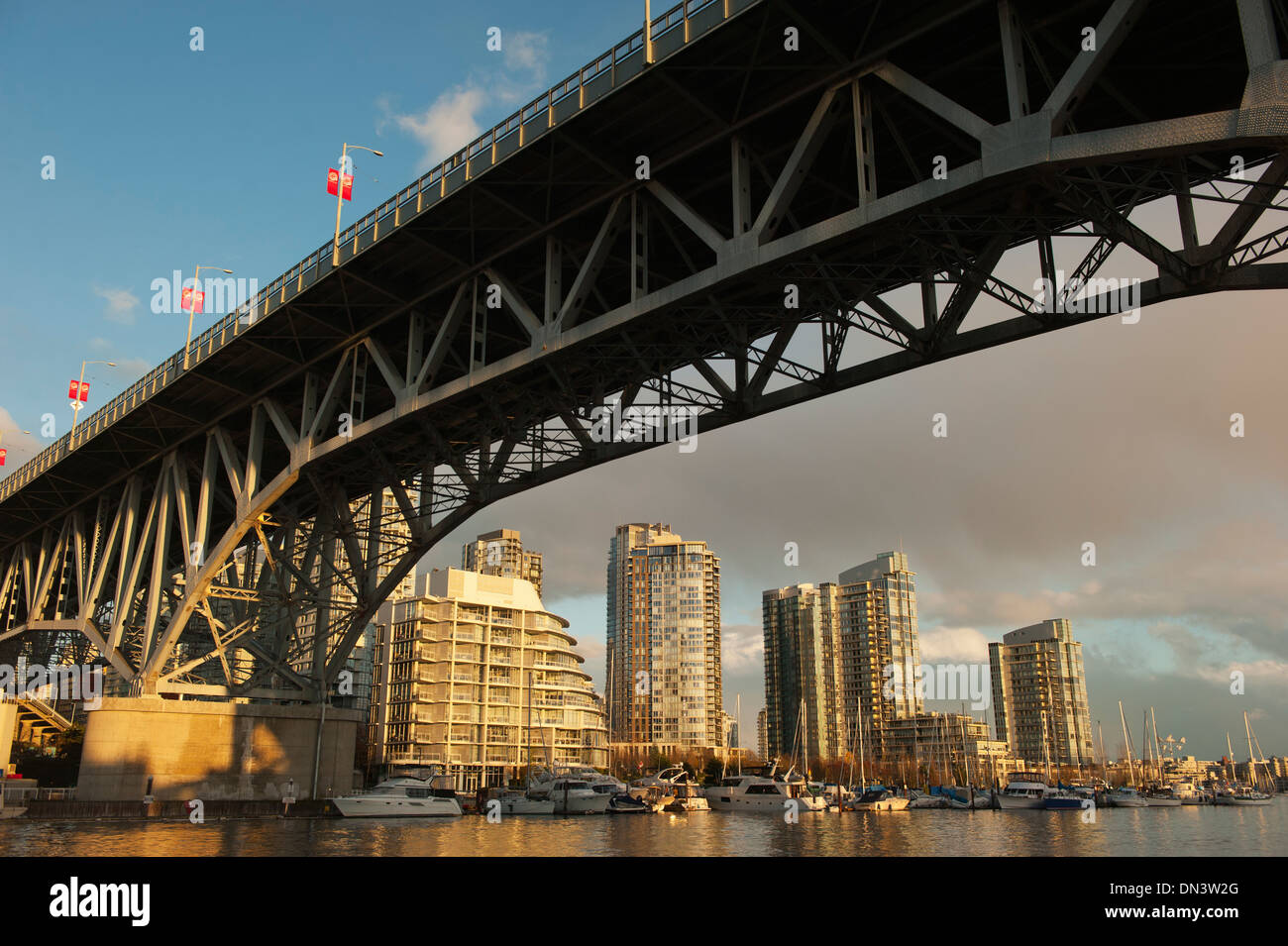 Reflection of Yaletown apartment buildings under Granville Bridge, Granville Island, Vancouver BC  Canada Stock Photo