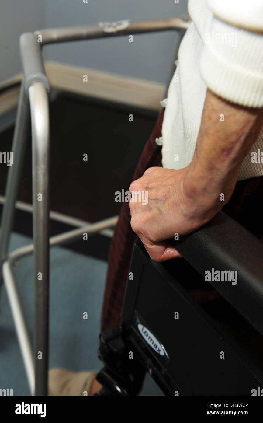 Elderly lady in a care home using a zimmer frame Stock Photo