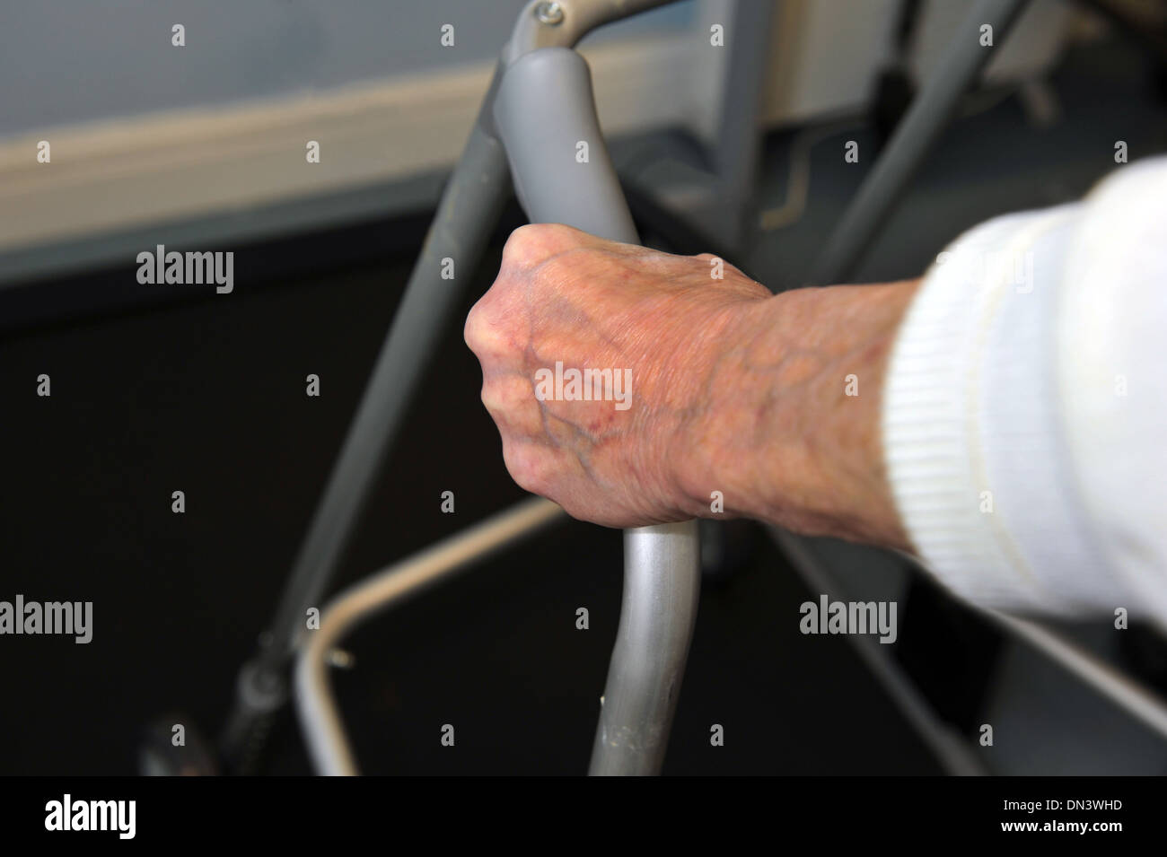 Close up of an Elderly lady's hand in a care home using a zimmer frame Stock Photo