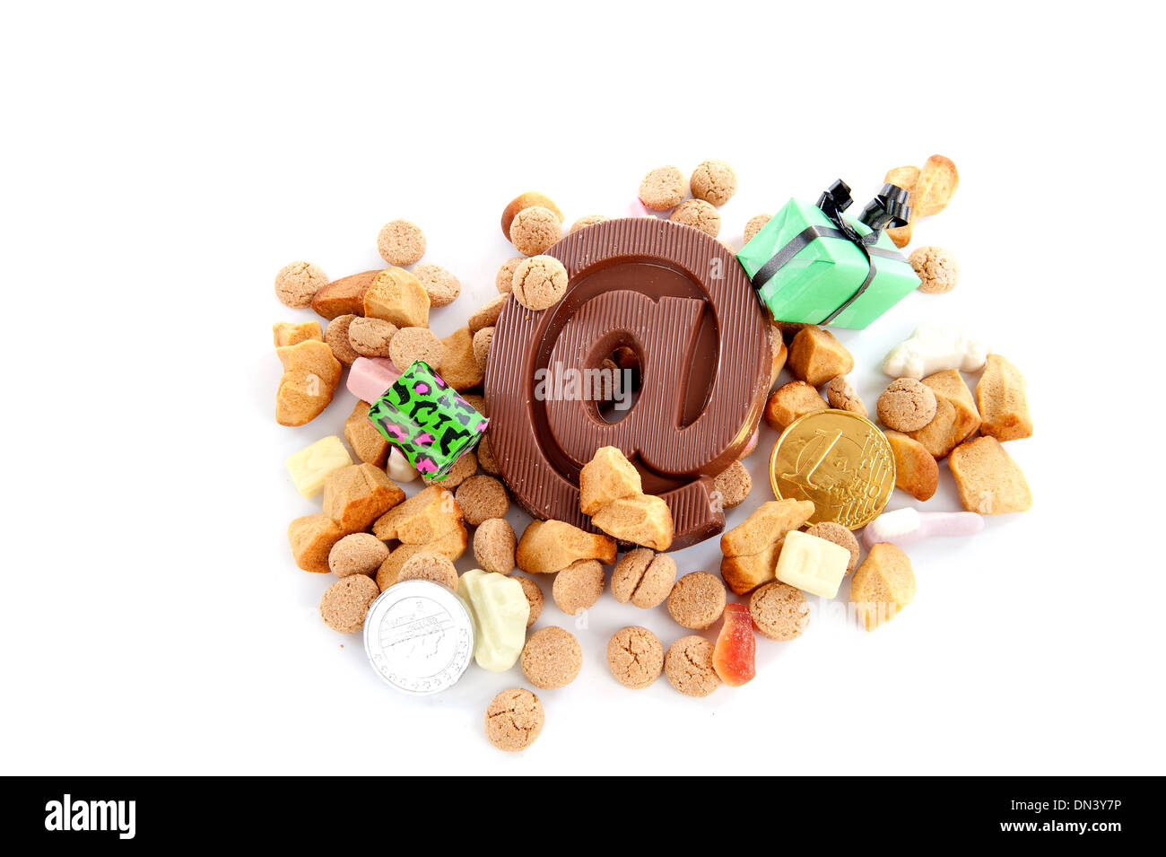 a atpersand, made of chocolate and a lot of other candies for Sinterklaas, on a white background Stock Photo