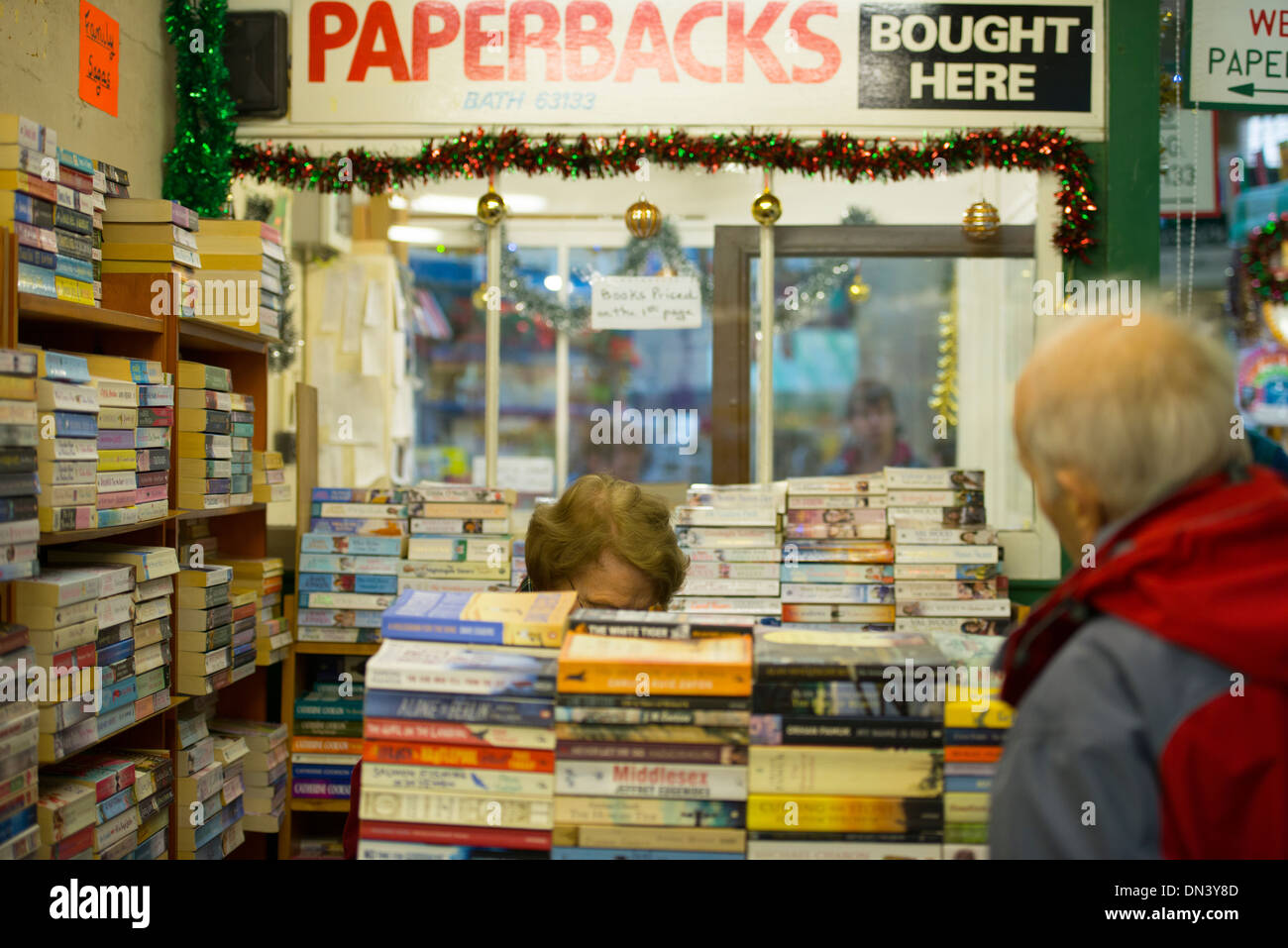 Customers perusing the book shelves in a second hand book shop in the ...