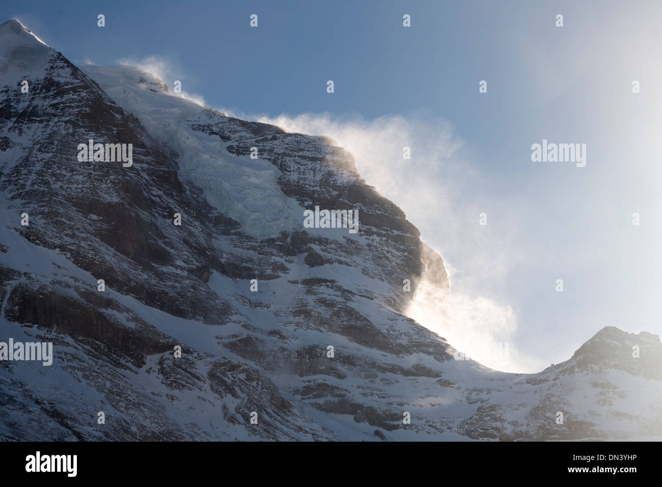 wind blowing the snow off the Jungfrau massif, Bernese Alps, Switzerland Stock Photo