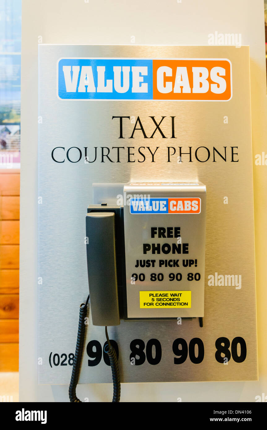 A courtesy phone for Value Cabs taxi company in Belfast in a local hotel Stock Photo