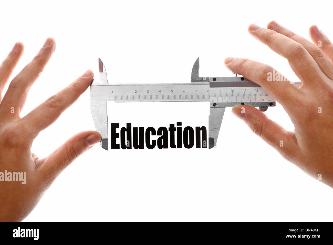 Student Using Calipers Two hands holding a caliper, measuring the word