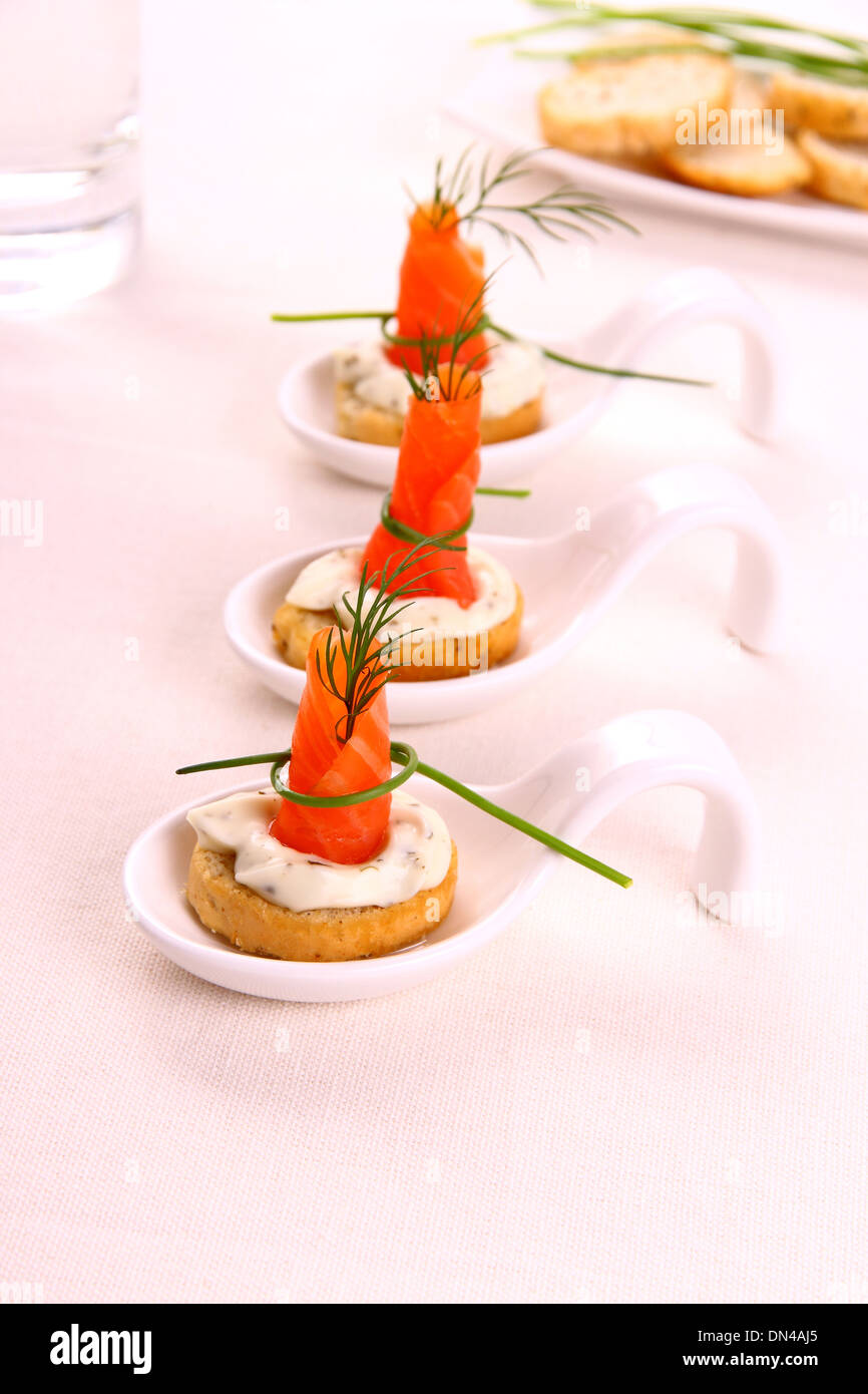 Smoked Lachsrollchen on white bread chunks, top view Stock Photo