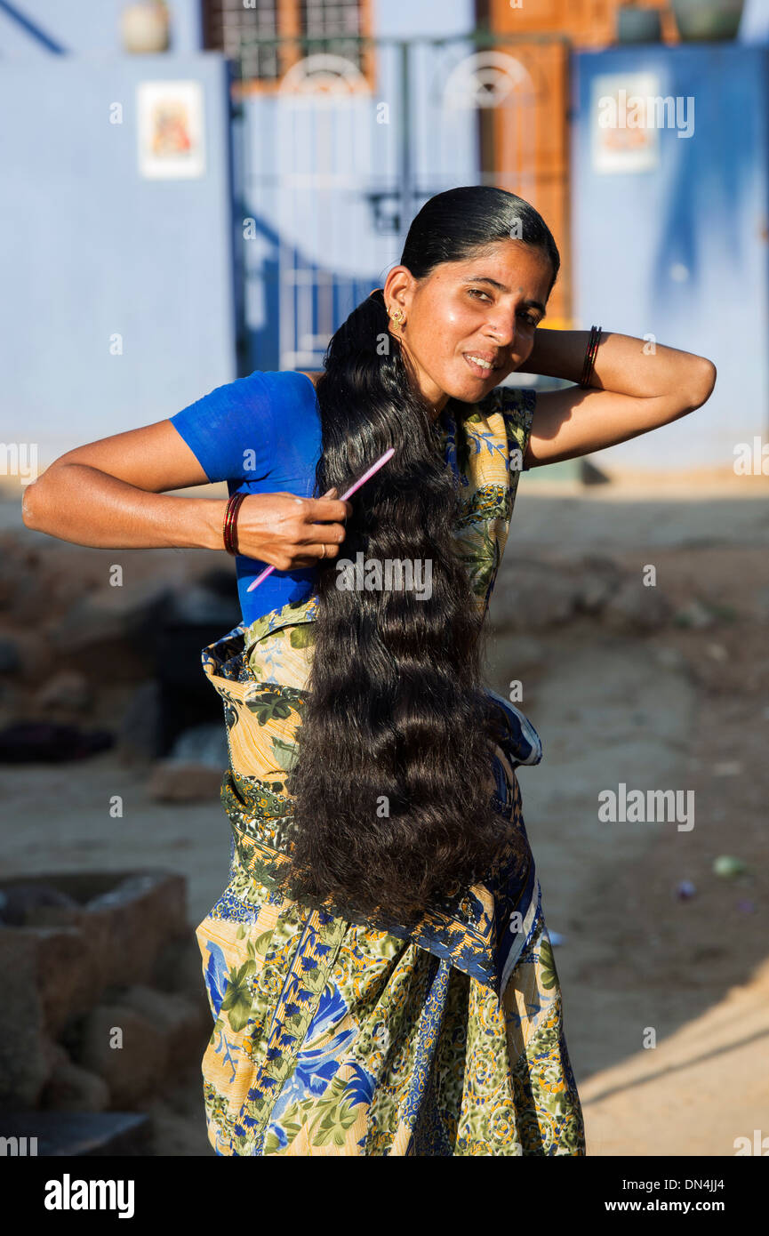 Indian woman brushing her long hair in a rural indian village. Andhra  Pradesh, India Stock Photo - Alamy