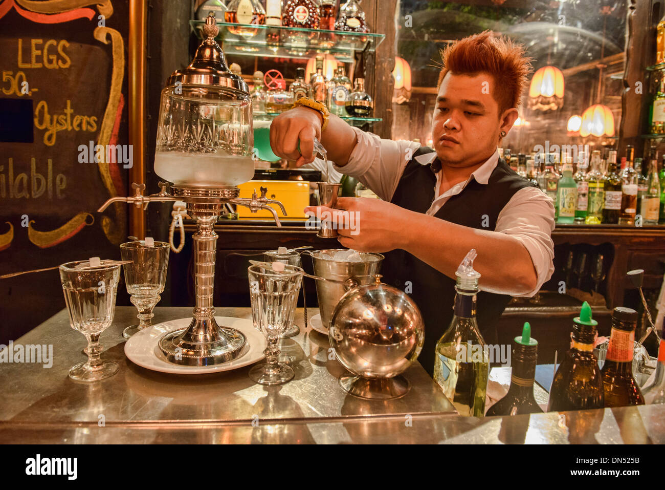 pouring absinthe the traditional way, Bangkok, Thailand Stock Photo