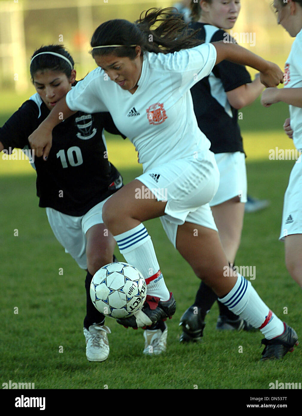 St. Joseph's Erica Jasso plays a ball in front of Salesian's Clarissa Ramirez (10) during their BSAL opener girls soccer game in Alameda, Calif., on Wednesday, November 28, 2007. .(Dean Coppola/Contra Costa Times/ZUMA Press) Stock Photo
