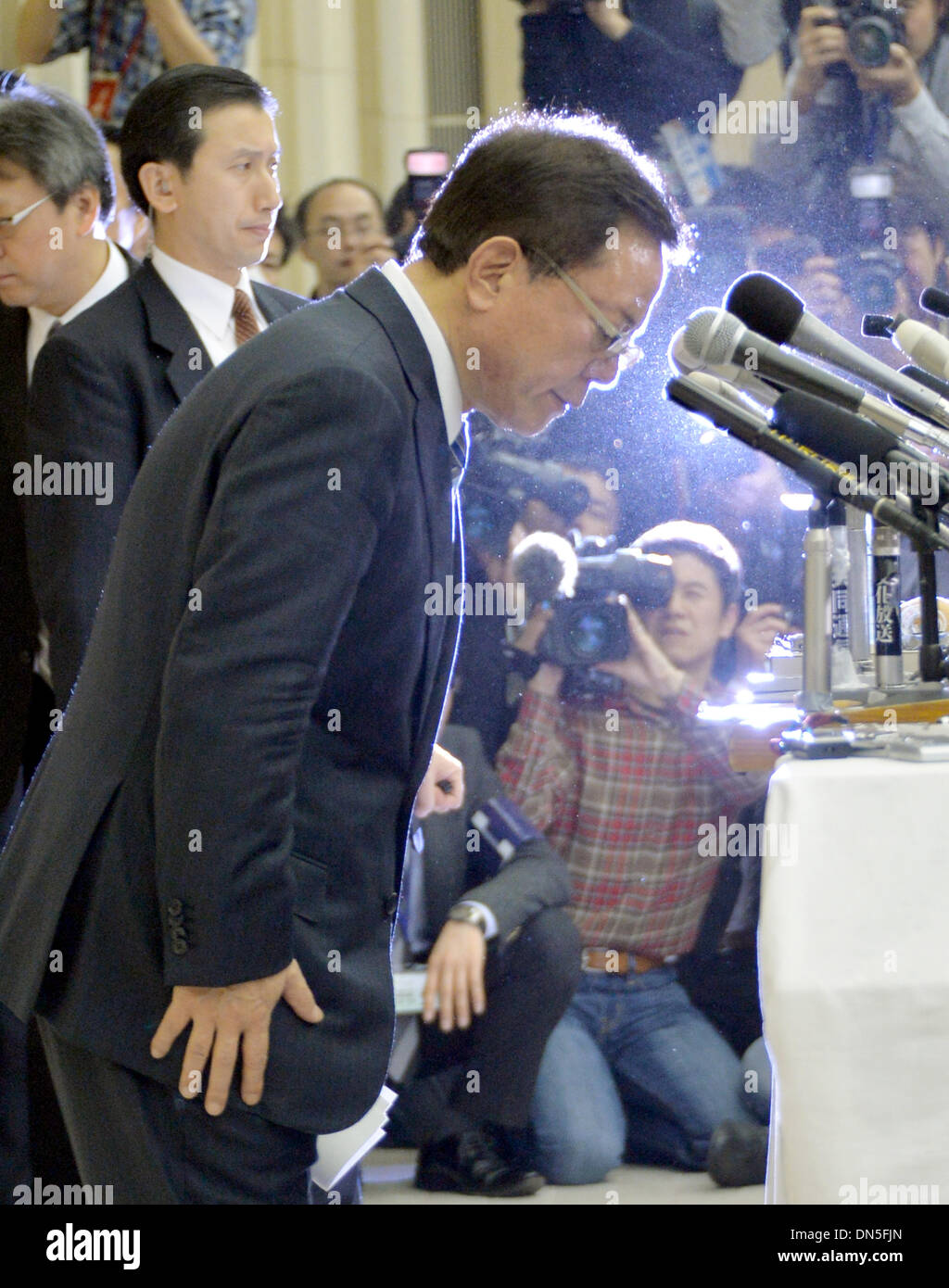 Tokyo, Japan. 19th Dec, 2013. Gov. Naoki Inose of Tokyo bows as he ...