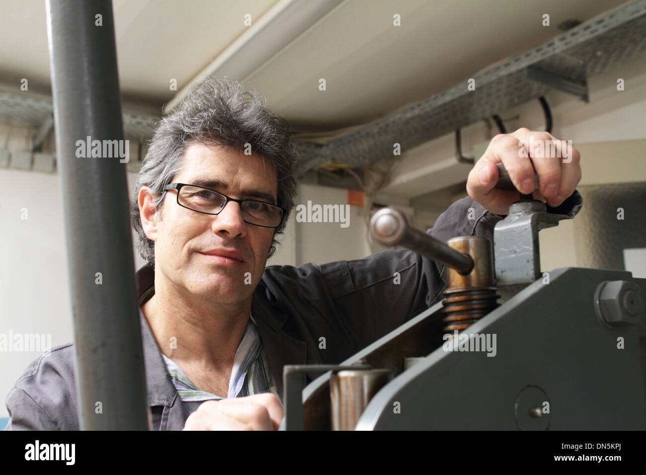 A technical worker engineer is working in factory or workshop Stock Photo