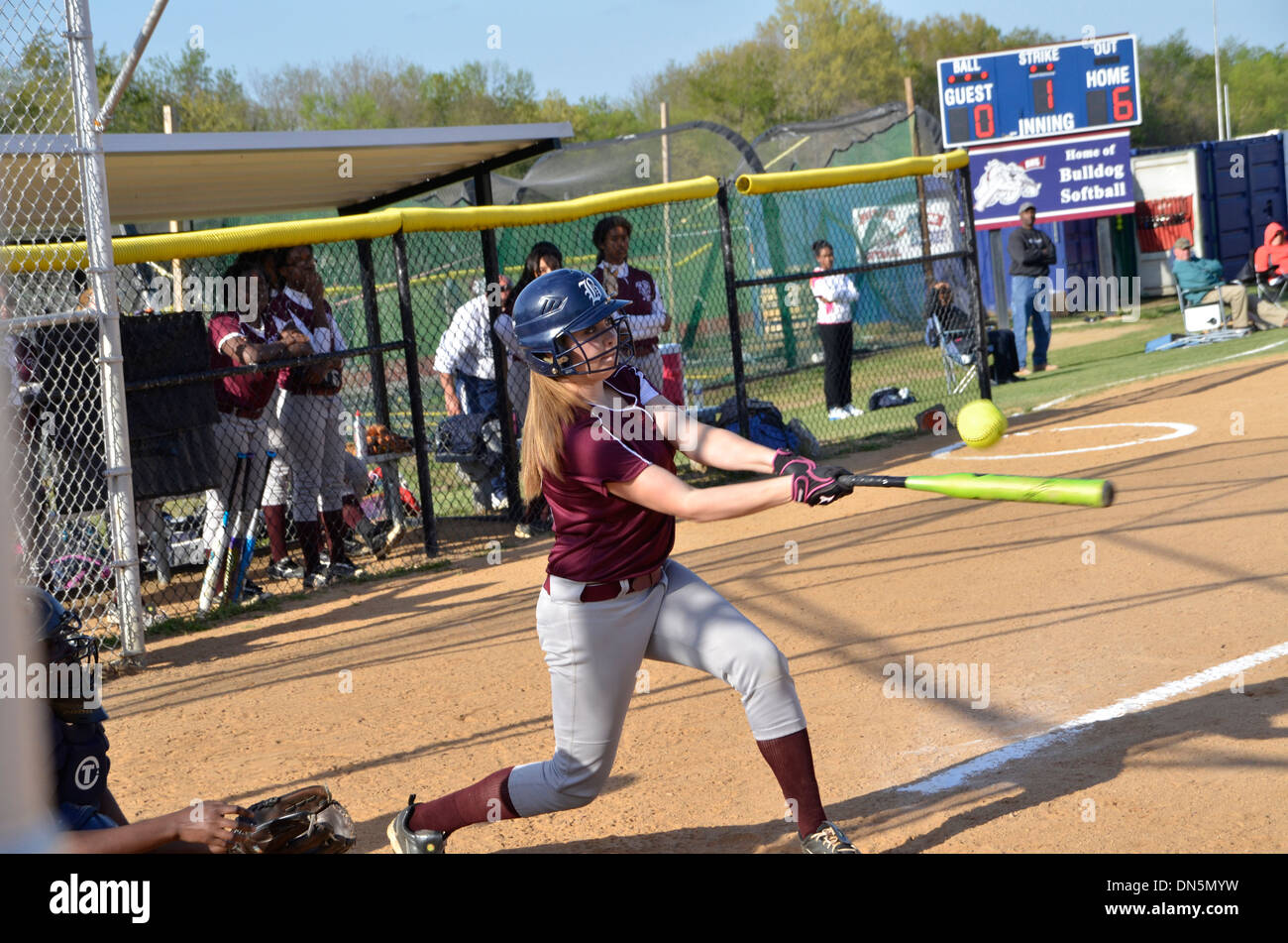 High school softball batter hits a softball game in Bowie, Maryland