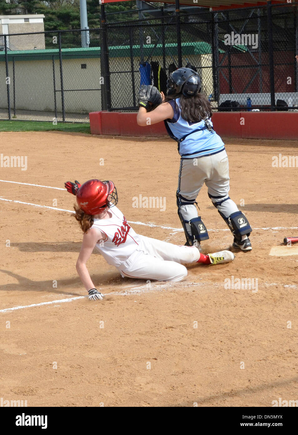 Play at the plate in a high school softball game Stock Photo