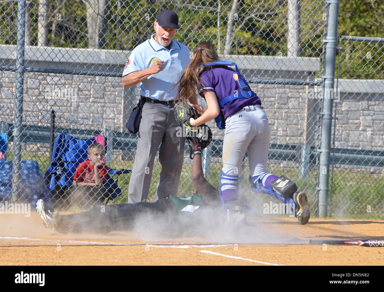 play at the plate at high school softball game Stock Photo Alamy