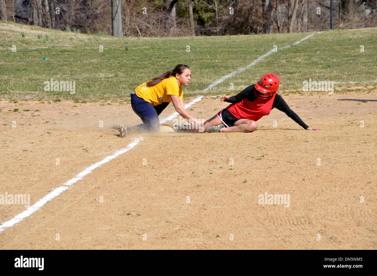 Play at third base in a high school softball game Stock Photo