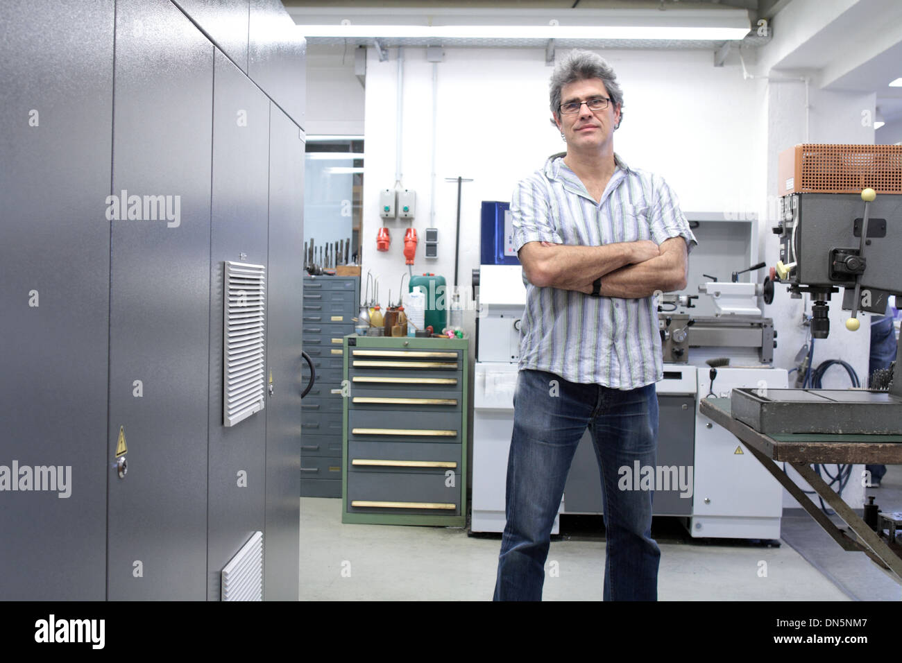 A technical worker engineer is working in factory or workshop Stock Photo