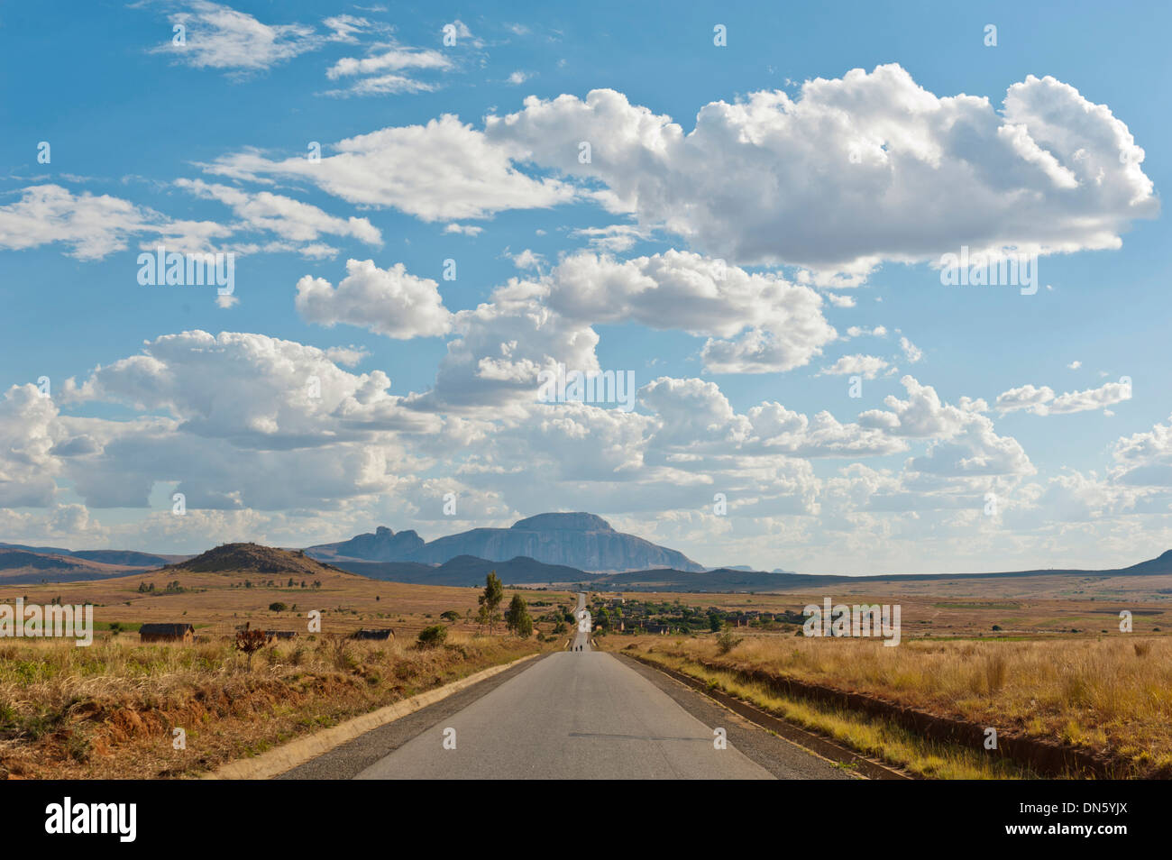 Long straight road, vast arid landscape, sky with clouds, Isalo National Park near Ranohira, Madagascar Stock Photo