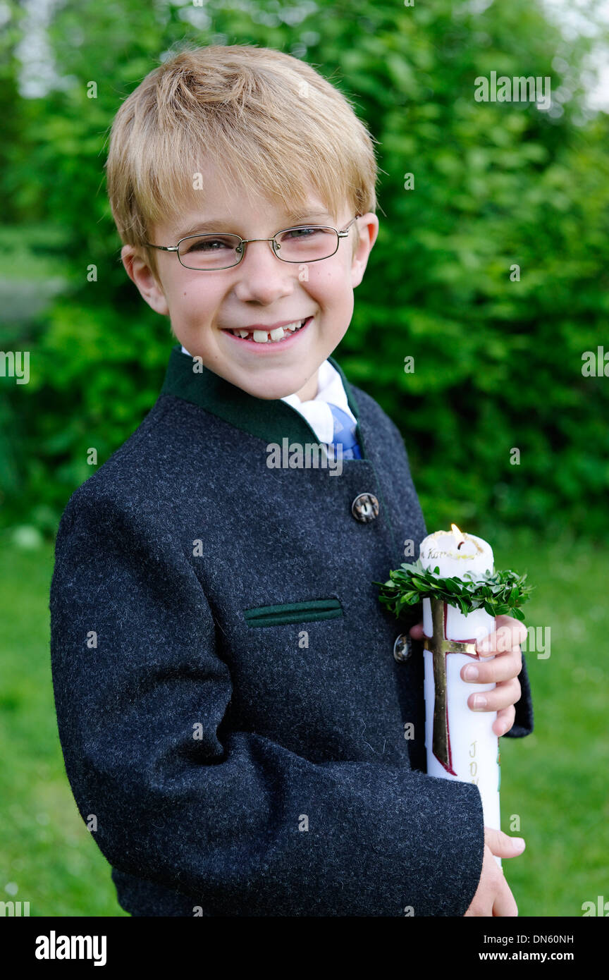 Boy holding a First Communion candle, Bavaria, Germany Stock Photo