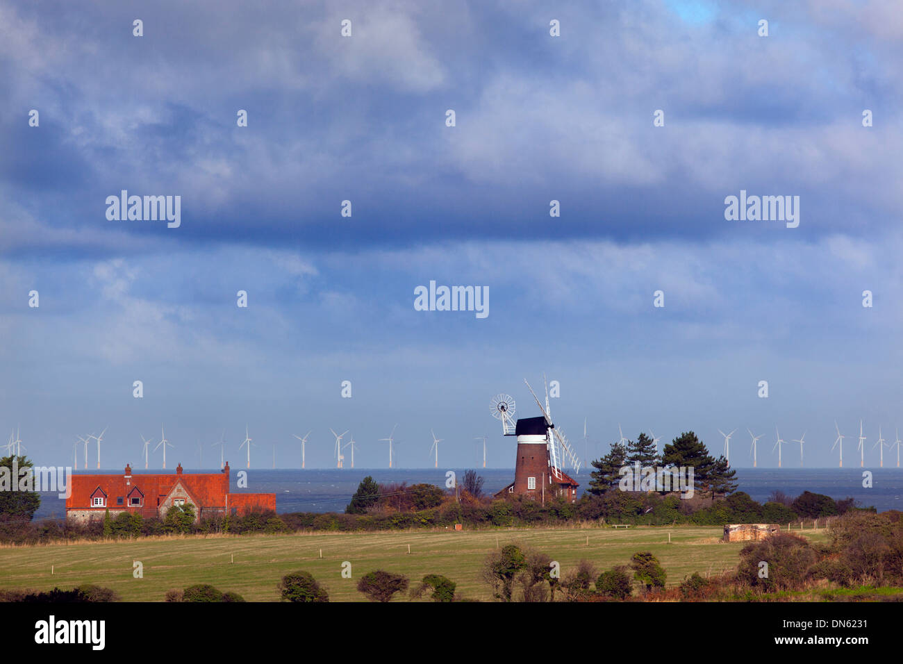 Historic Windmill and Sheringham Shoal wind farm in the North sea from Weybourne Norfolk Stock Photo
