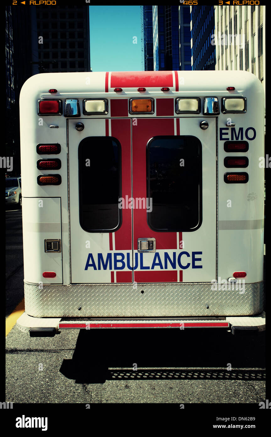 Ambulance parked on city street Stock Photo