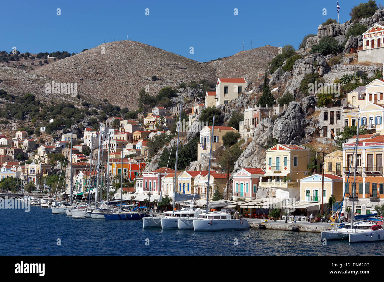 Harbour of the town of Symi with picturesque houses in the neo-classical style, Symi, Symi Island, Dodecanese, Greece Stock Photo