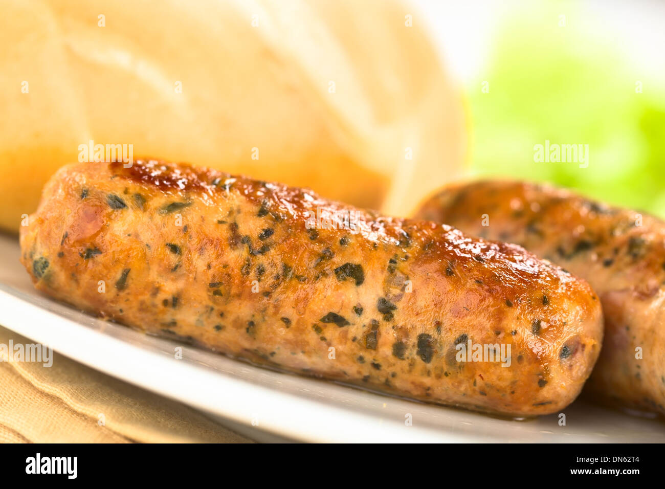 Fried bratwurst with bun, traditional German fast food served on plate Stock Photo