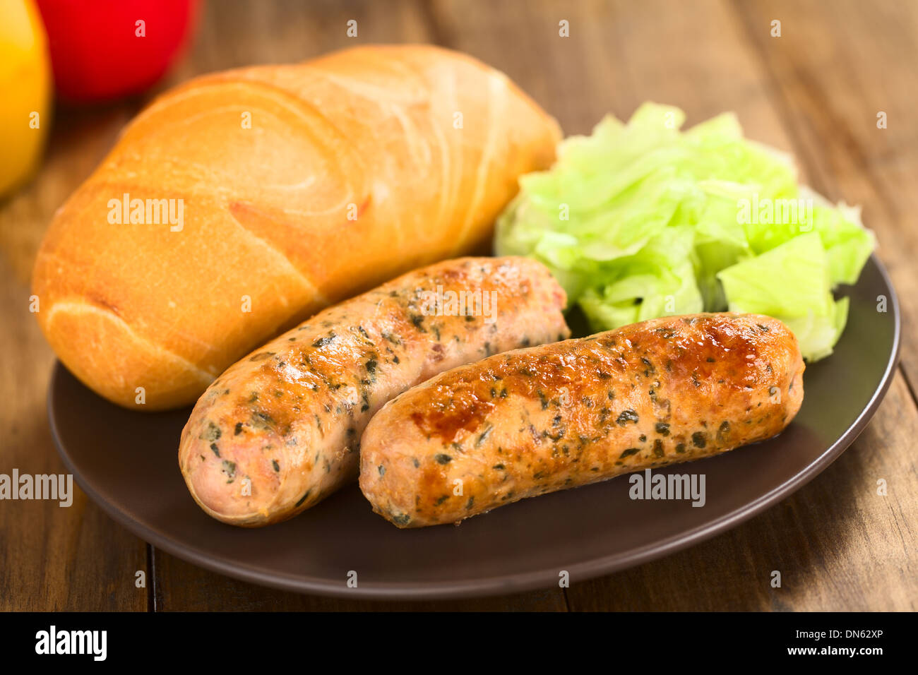 Fried bratwurst with bun, traditional German fast food served on plate