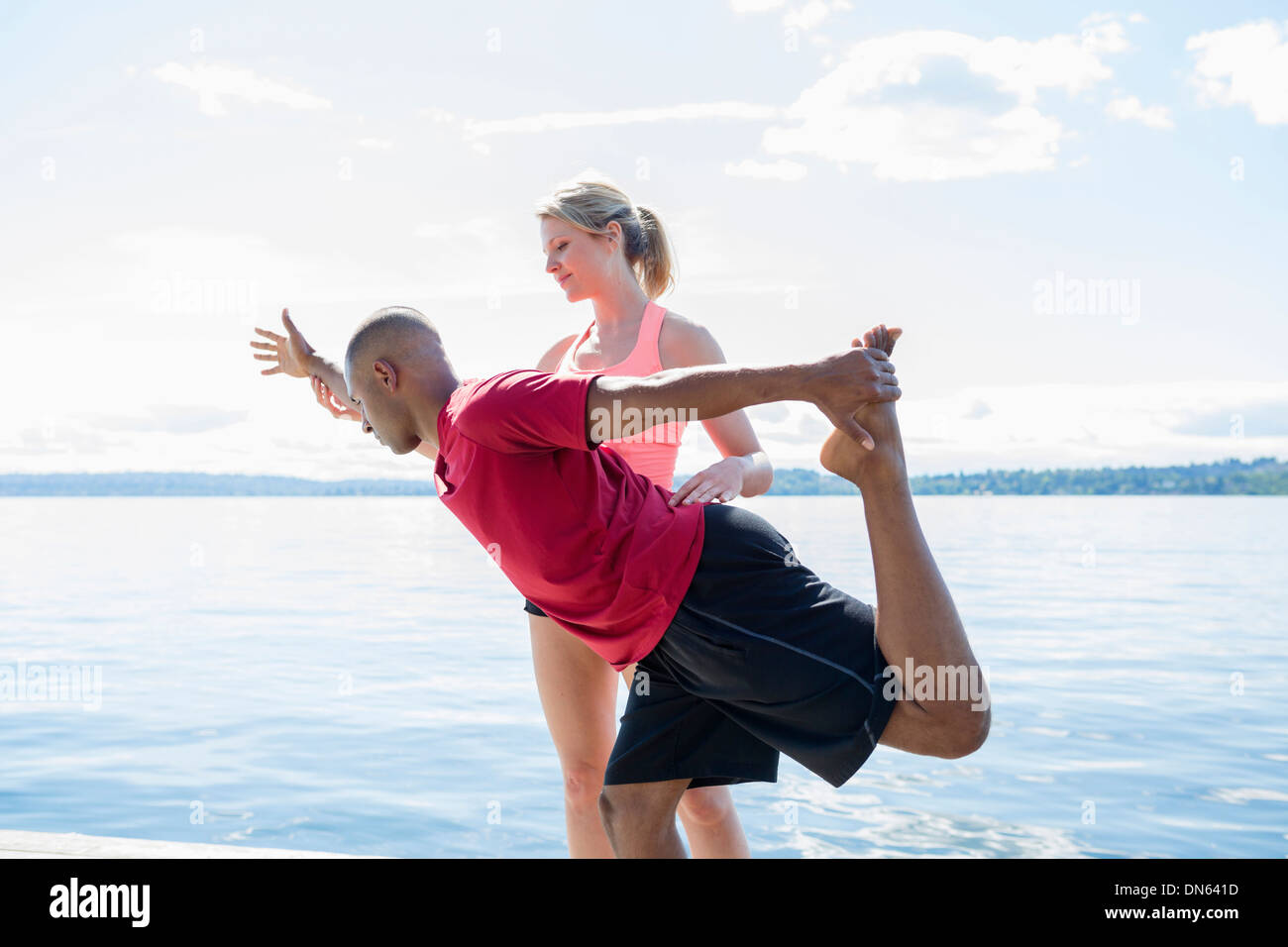 Caucasian man practicing yoga with teacher Stock Photo