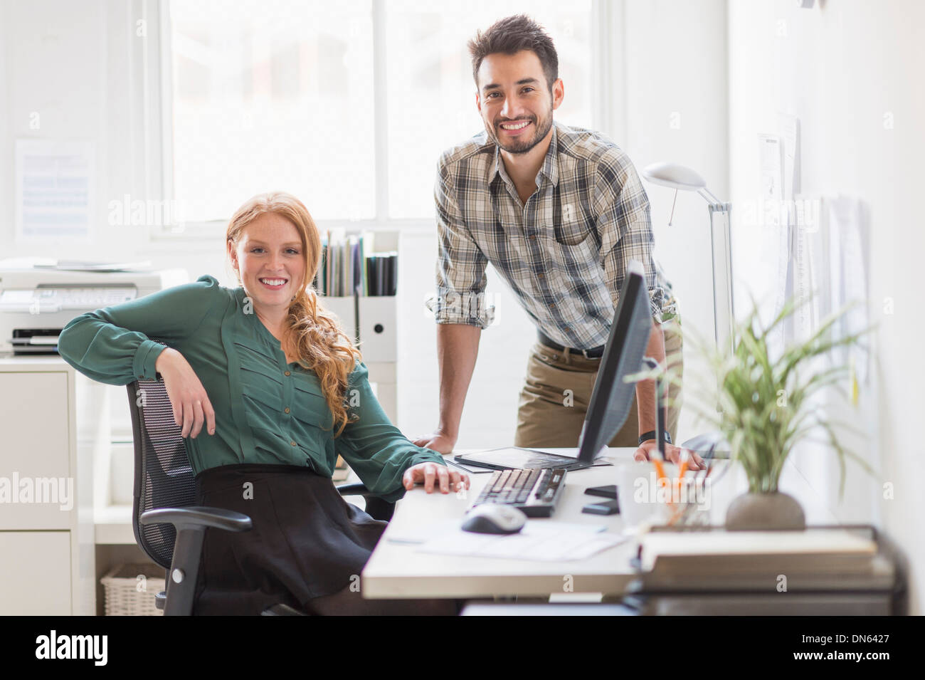 Business people smiling together in office Stock Photo - Alamy